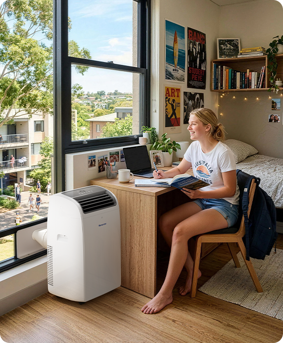 Student studying in an apartment cooled by a Newentor portable air conditioner