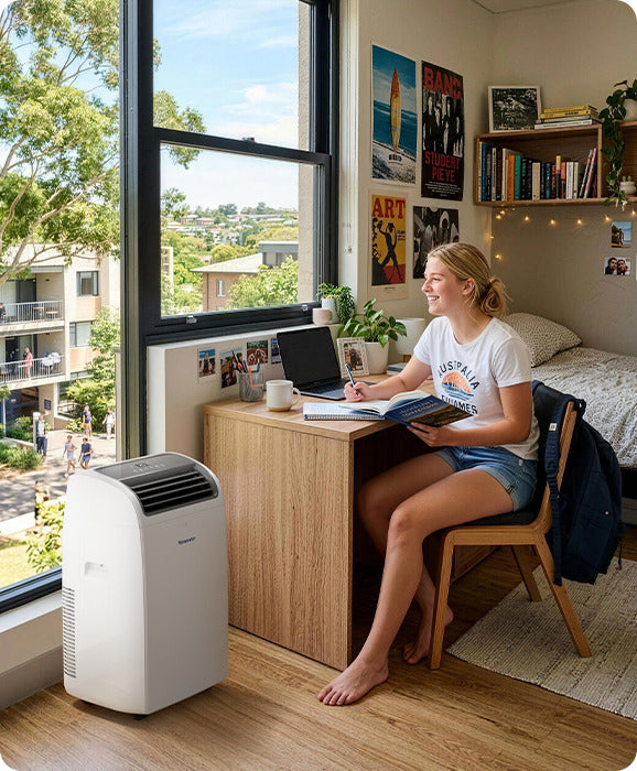 Student studying in an apartment cooled by a Newentor portable air conditioner